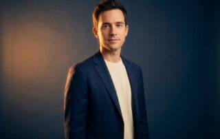 Confident man standing in warm light, representing clinical awareness and dignity around micropenis as a medical condition.