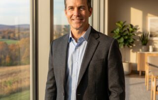 Confident man at Pennsylvania wellness center window — penis girth enhancement Pennsylvania at Chadds Ford